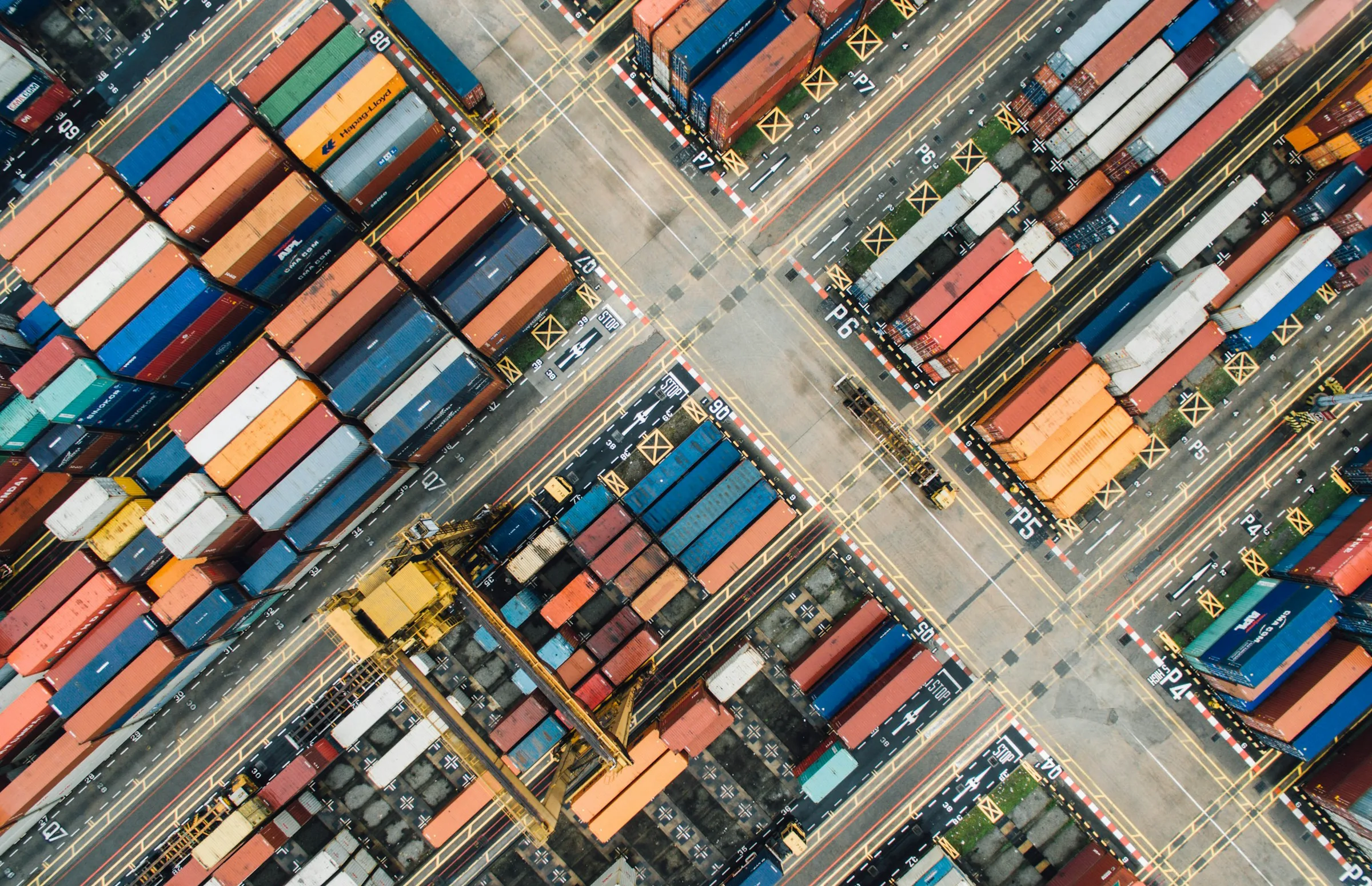 Aerial view of stacked shipping containers at a port terminal